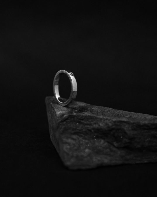 band ring made from sterling silver and subtly highlighted with white moissanite. it will fit you like a second skin thus the day will not pass by without wearing it.