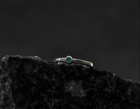 a round silver ring that feels glamorous without being over-the-top ___a super slim band works to make this emerald sparkler feel dainty on the hand.
