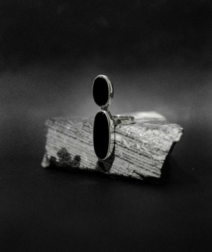 fit for the glamorous and etheral woman ___sterling silver flanked with two different size onyx stones that's set in a whimsical design for an extra touch of magic.