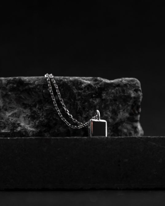 with a 7mm square onyx stone set in the center of a sterling silver frame, this pendant will create a captivating and magnetic atmosphere around you at all times ___match with our 170321 ring. silver chains are not included and must be purchased separately.