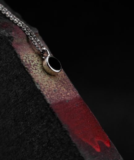 pendant with a 7 mm onyx set in the center of a sterling silver frame ___match with our 160820 ring and 101150 earrings. silver chains are not included and must be purchased separately.