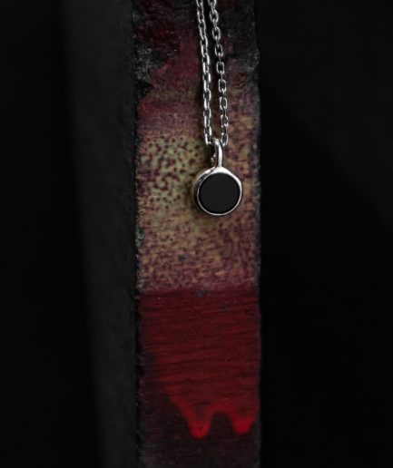 pendant with a 7 mm onyx set in the center of a sterling silver frame ___match with our 160820 ring and 101150 earrings. silver chains are not included and must be purchased separately.