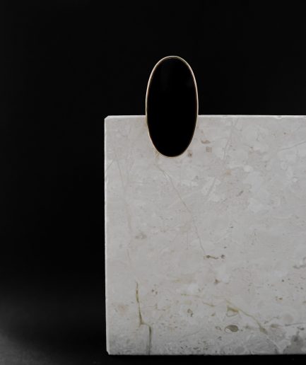 anchored by a beautifully faceted onyx that pops against the shiny gold-plated sterling silver setting and is made for a look that's both vintage inspired and feminine.